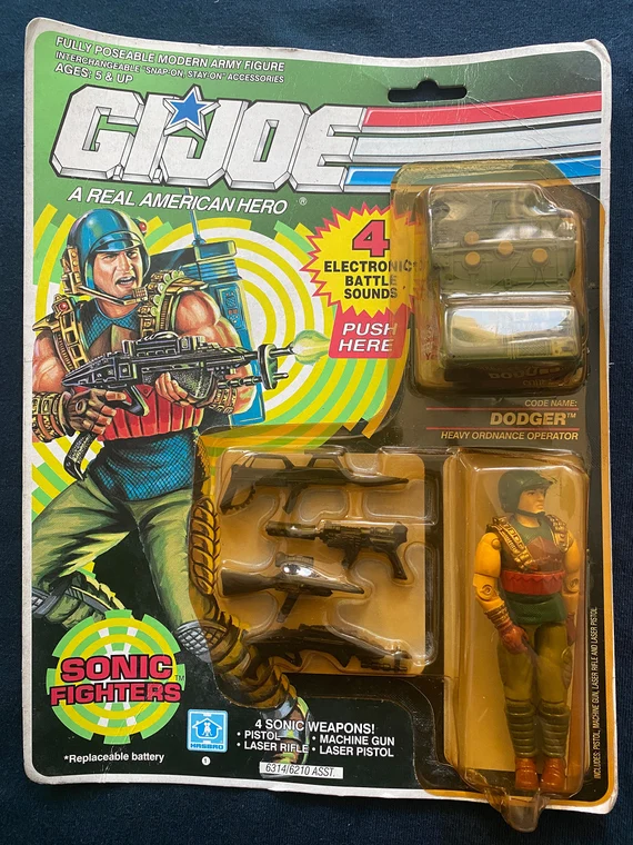 Image direction: close detail showing different condition axes on one packaged figure - card edge wear, bubble yellowing, clean figure, punch state or sticker wear.