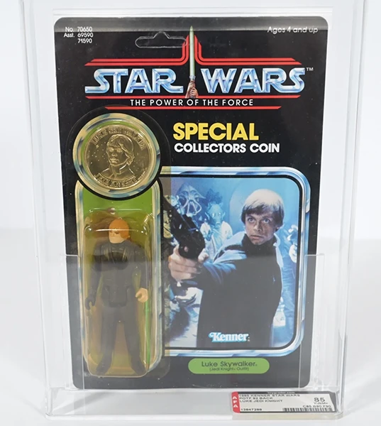 Image direction: a professionally graded carded or loose action figure beside an ungraded equivalent, emphasizing the visual and cultural difference created by encapsulation.
