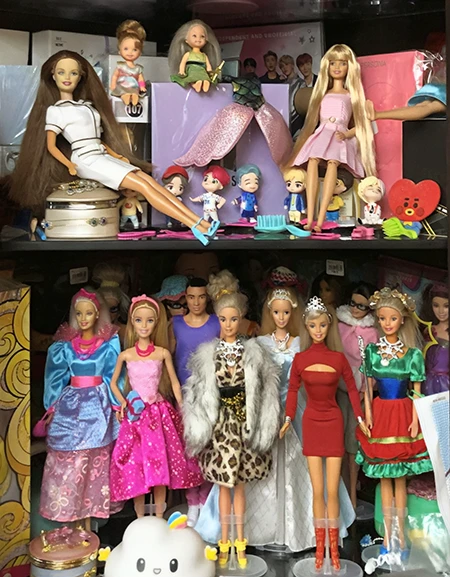 Hero image direction: a visually strong Barbie arrangement that communicates collecting depth rather than a single doll - ideally vintage doll, fashion pieces, packaging and one later collector example together.