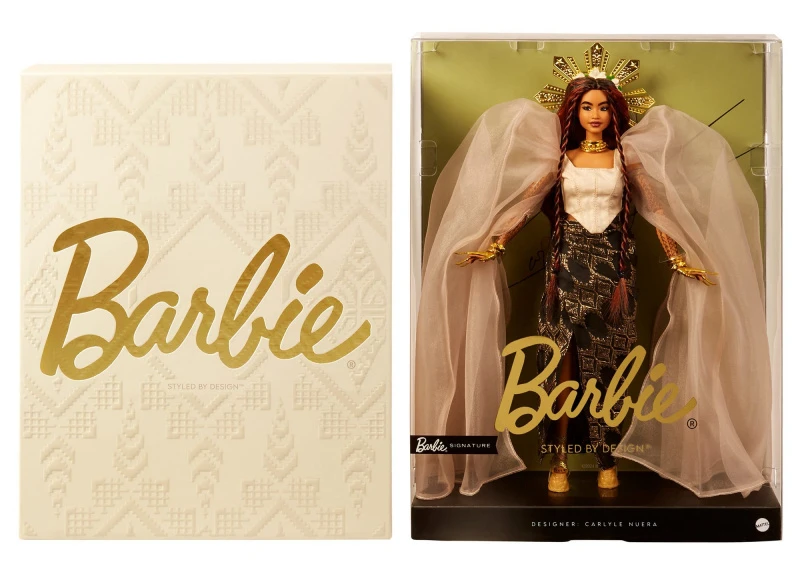Image direction: Barbie Signature / collector-release packaging, convention material or a release display that makes the manufacturer-created collector ecosystem visible without resembling a retail advertisement.
