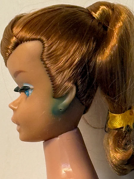Image direction: detailed macro evidence of Barbie-specific condition issues - green ear, face paint loss, vinyl colour shift or a neck split. Prefer diagnostic clarity over a damaged-doll collage.