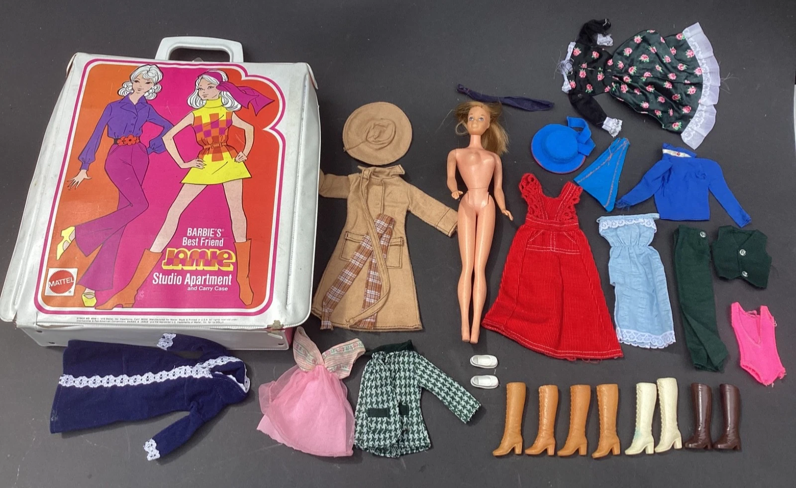 Image direction: a complete vintage Barbie fashion laid out component-by-component beside the dressed doll - shoes, gloves, handbag, belt, jewellery and other small pieces visible separately.