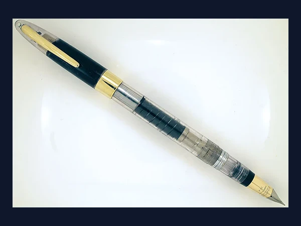 Image direction: a Sheaffer Snorkel, demonstrator or another pen where the filling mechanism is visually legible. Prefer cutaway, transparent or disassembled evidence over a polished product shot.
