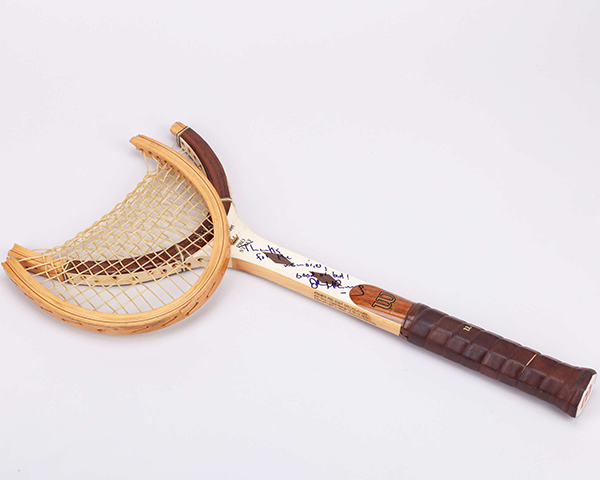 A historic John McEnroe tennis racket associated with Wimbledon.