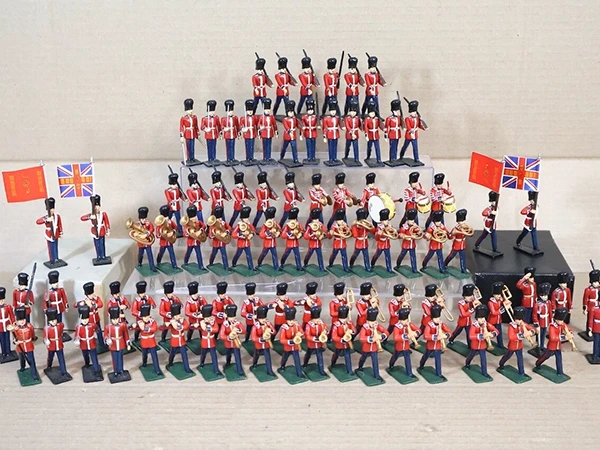 A collection of vintage toy soldiers and detailed military miniatures in different materials and scales.